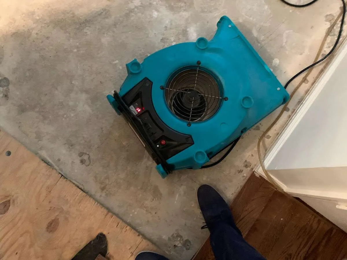 Air mover drying subfloor during Commercial Water Damage Restoration in Stallings